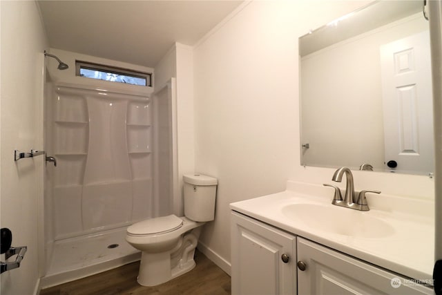 bathroom with wood-type flooring, vanity, toilet, and walk in shower