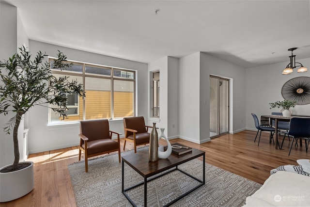 living room featuring wood-type flooring and a chandelier