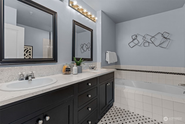 bathroom featuring vanity, tile patterned floors, and tiled tub