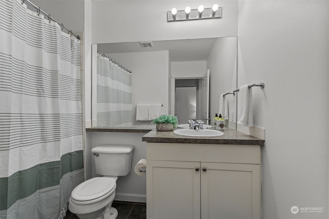 bathroom with toilet, vanity, tile patterned floors, and curtained shower