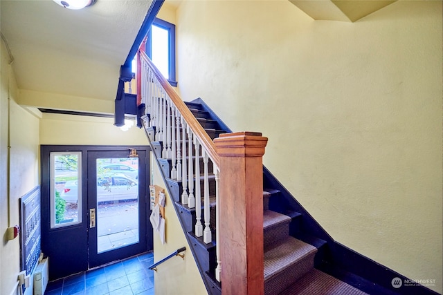 staircase with tile patterned floors