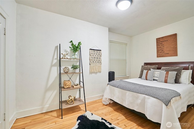 905 NE 43rd St Unit 108, Seattle, WA 98105 - bedroom featuring wood finished floors and baseboards