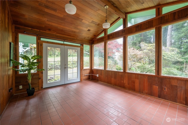 unfurnished sunroom featuring wooden ceiling, a wealth of natural light, vaulted ceiling with beams, and french doors