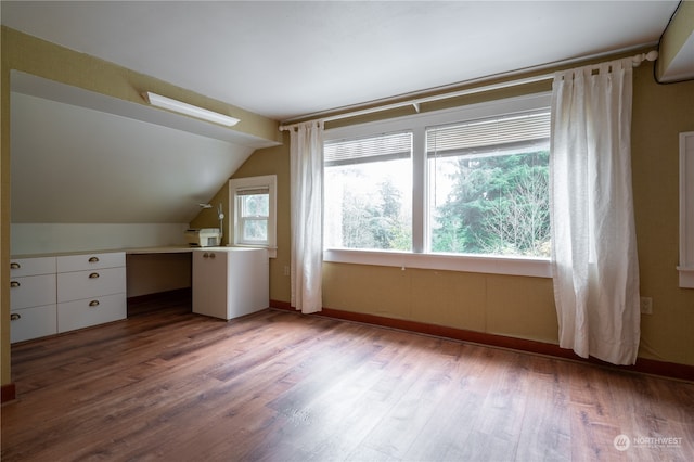 bonus room with vaulted ceiling and light hardwood / wood-style floors