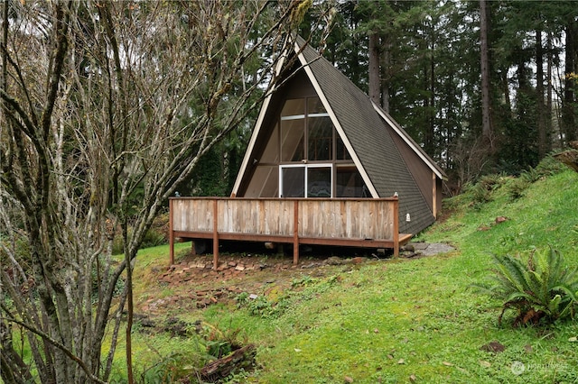 rear view of property featuring a wooden deck