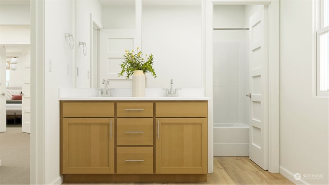 18016 139th Pl E, Puyallup, WA 98374 - ensuite bathroom featuring double vanity, wood finished floors, and baseboards