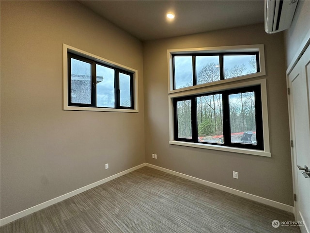 empty room with an AC wall unit and carpet