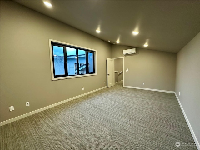 carpeted empty room with an AC wall unit and vaulted ceiling