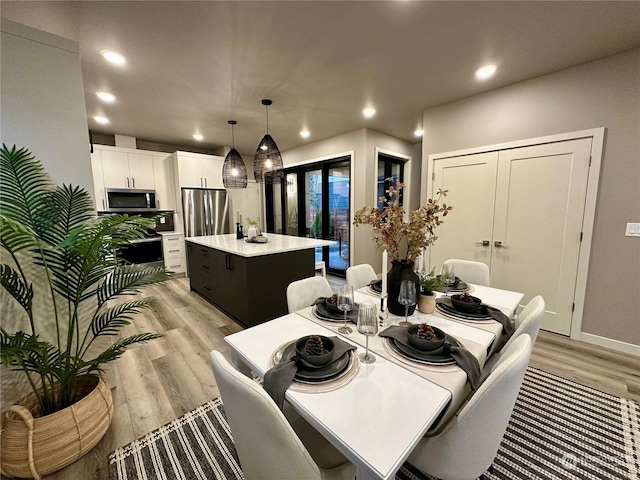 dining space with light hardwood / wood-style floors