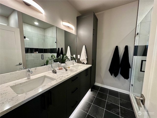 bathroom with tile patterned flooring, a shower with shower door, and vanity