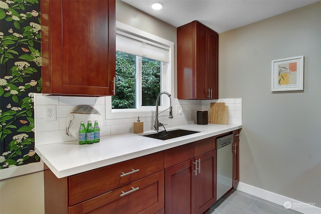 kitchen featuring decorative backsplash, sink, light tile patterned flooring, and stainless steel dishwasher