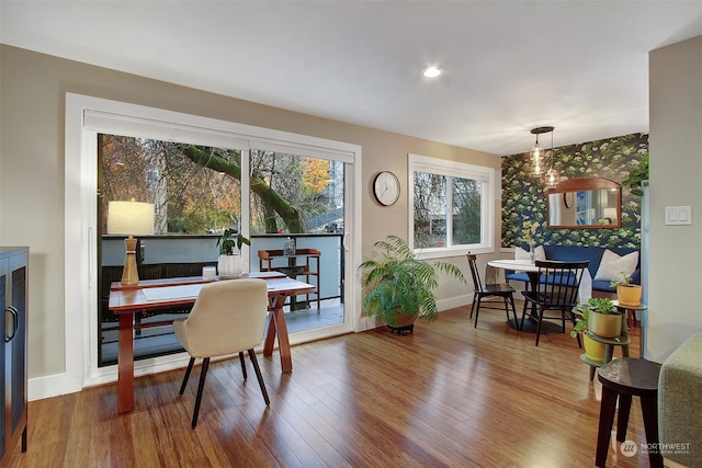 dining space with wood-type flooring