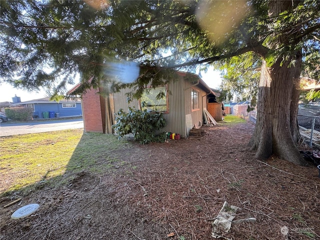 view of property exterior with a lawn