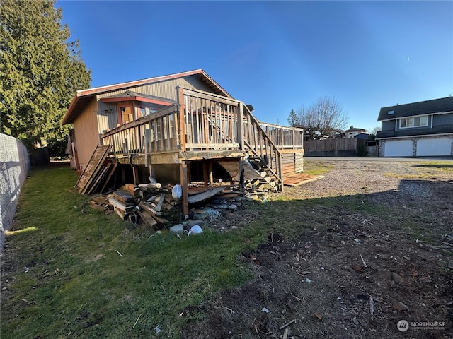 rear view of property featuring a deck