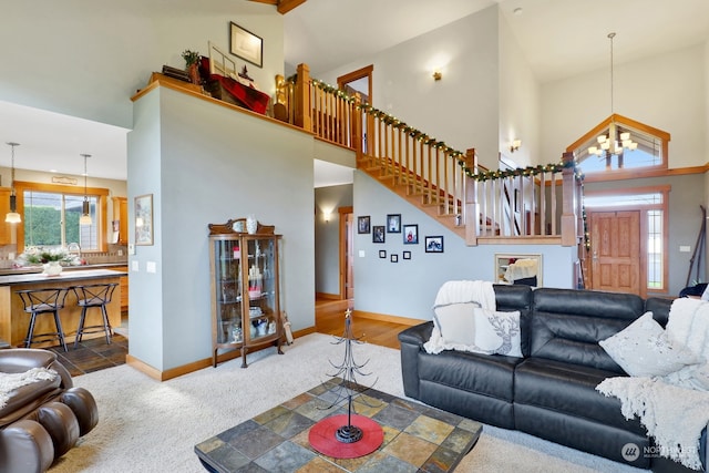 living room featuring wood-type flooring, an inviting chandelier, and high vaulted ceiling