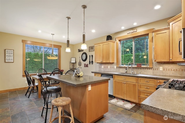 kitchen with a kitchen island, sink, light brown cabinetry, and tasteful backsplash