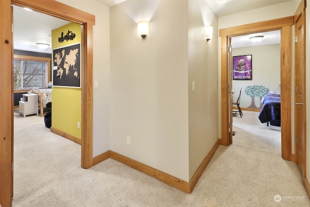 corridor featuring light colored carpet