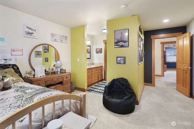 carpeted bedroom featuring connected bathroom