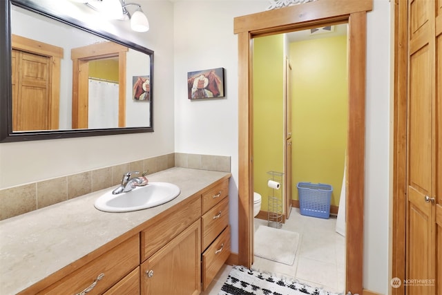 bathroom with tile patterned floors, vanity, and toilet