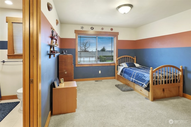 carpeted bedroom with ensuite bathroom