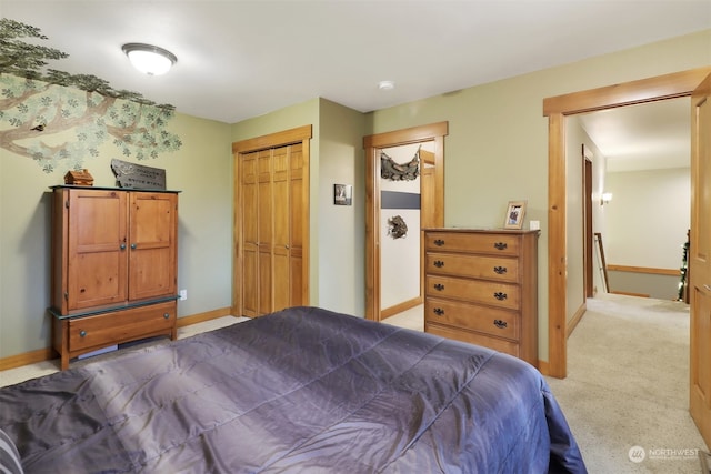 bedroom featuring light colored carpet and a closet