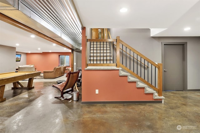 stairway with concrete flooring