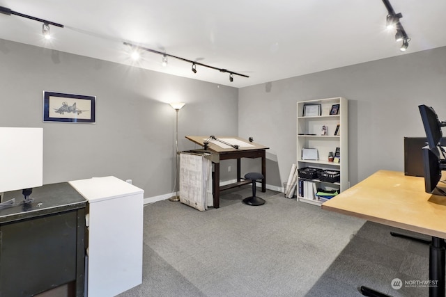 carpeted office featuring track lighting