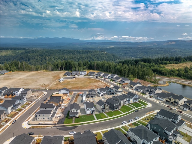 bird's eye view with a water and mountain view