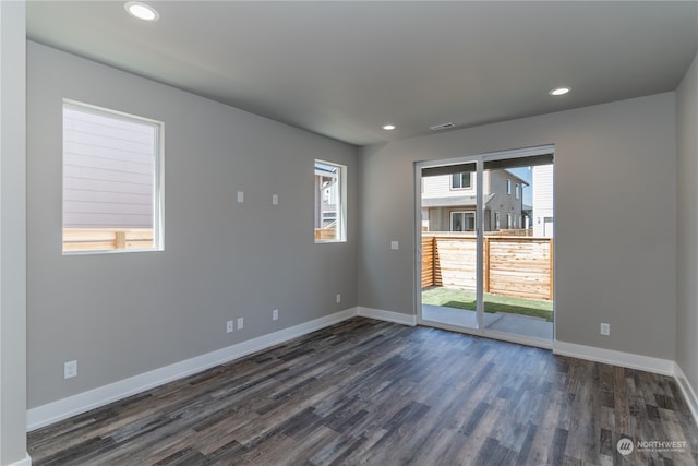 empty room with dark hardwood / wood-style flooring