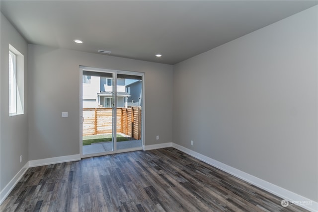 unfurnished room featuring dark wood-type flooring