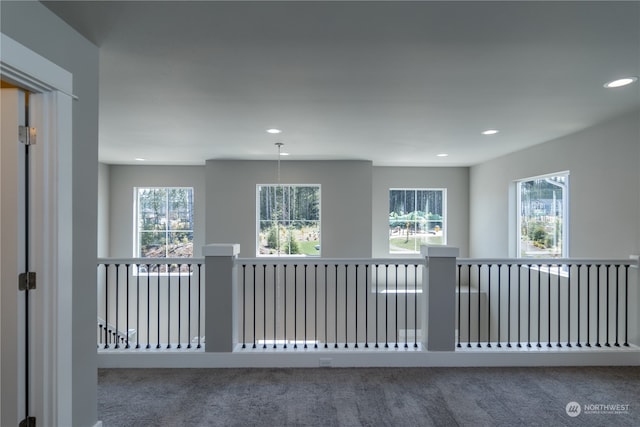 interior space with plenty of natural light and carpet