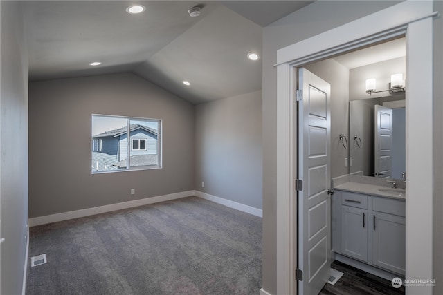 interior space with vanity and lofted ceiling