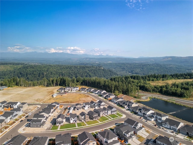 birds eye view of property featuring a water and mountain view