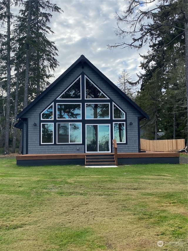 rear view of house featuring a lawn