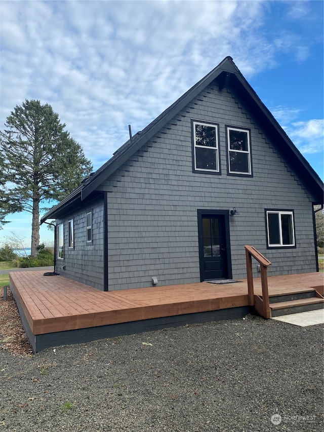 view of side of home with a wooden deck