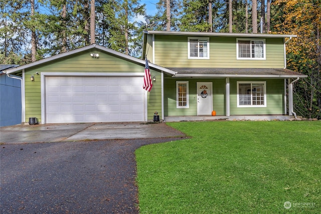 front facade with a front lawn, covered porch, and a garage