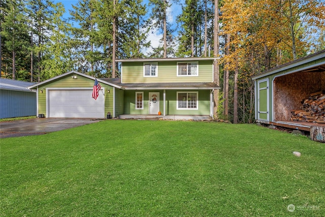 view of front facade featuring a porch, an outbuilding, a front yard, and a garage