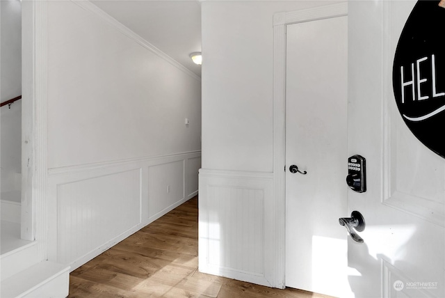 22222 Bluewater Dr SE, Yelm, WA 98597 - corridor with wood finished floors, crown molding, wainscoting, and a decorative wall