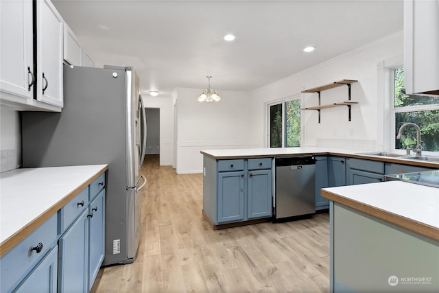 22222 Bluewater Dr SE, Yelm, WA 98597 - kitchen featuring stainless steel appliances, a sink, a chandelier, ornamental molding, and healthy amount of natural light