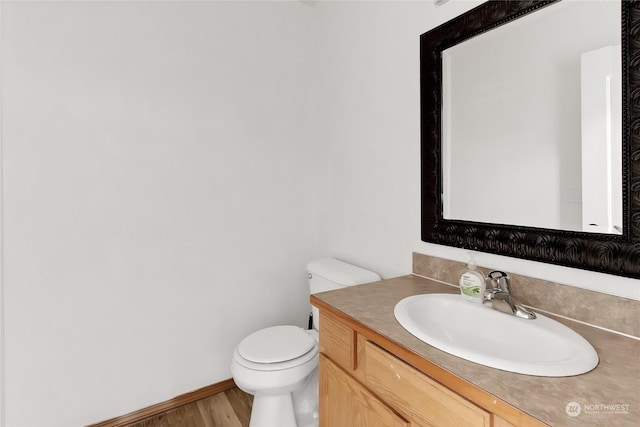 22222 Bluewater Dr SE, Yelm, WA 98597 - bathroom featuring toilet, vanity, wood finished floors, and baseboards