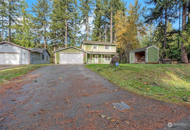 22222 Bluewater Dr SE, Yelm, WA 98597 - traditional home featuring driveway, a front yard, view of scattered trees, and an attached garage