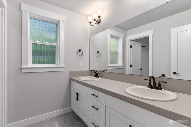 bathroom with tile patterned floors and vanity