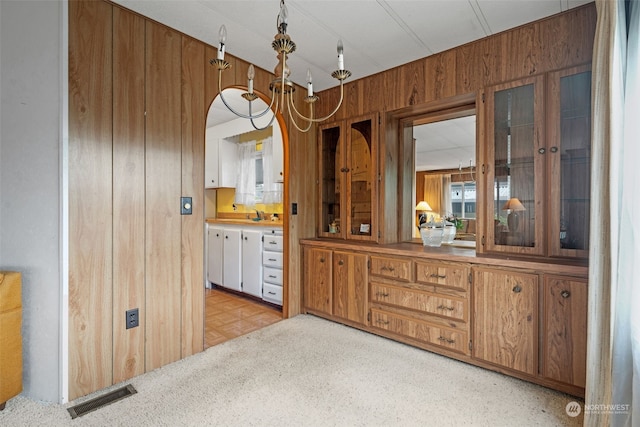 dining room with light parquet floors and wood walls