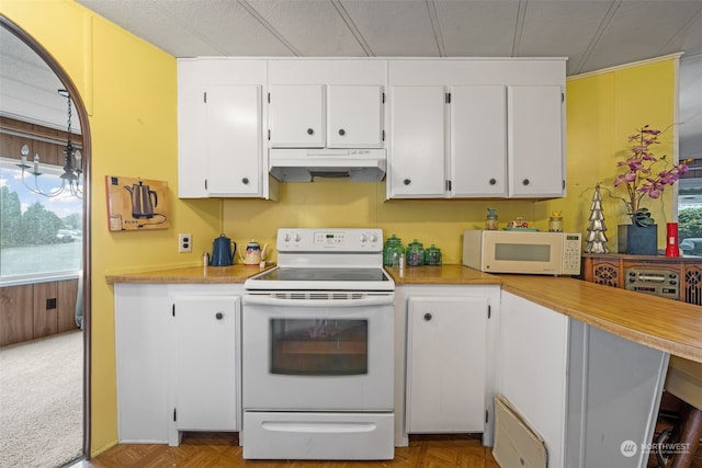 kitchen with light parquet flooring, white cabinets, and white appliances