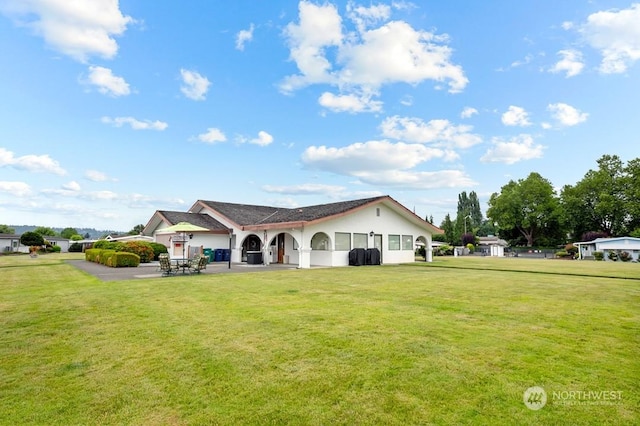 view of front of house featuring a patio area and a front lawn