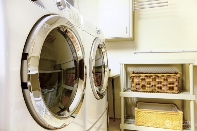 clothes washing area with washer and clothes dryer