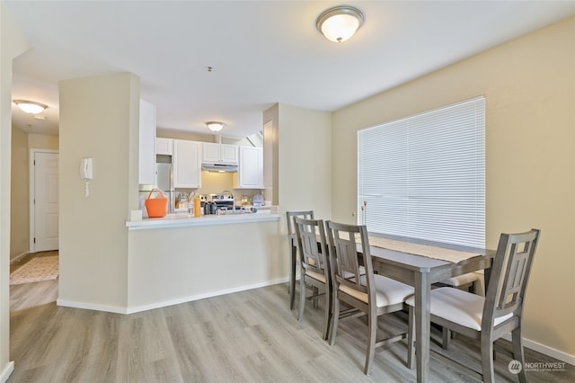 dining space with light wood-type flooring