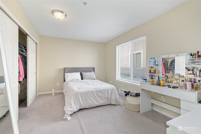 bedroom featuring a closet and light carpet