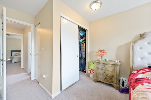 bedroom with a closet and light colored carpet