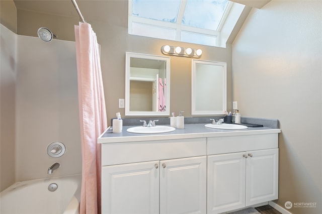 bathroom featuring shower / tub combo with curtain, vanity, and a skylight